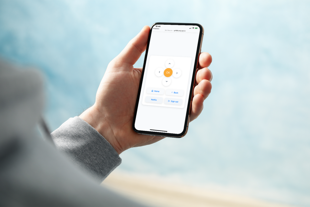hand holding phone with OnlyCast's virtual remote, blue background